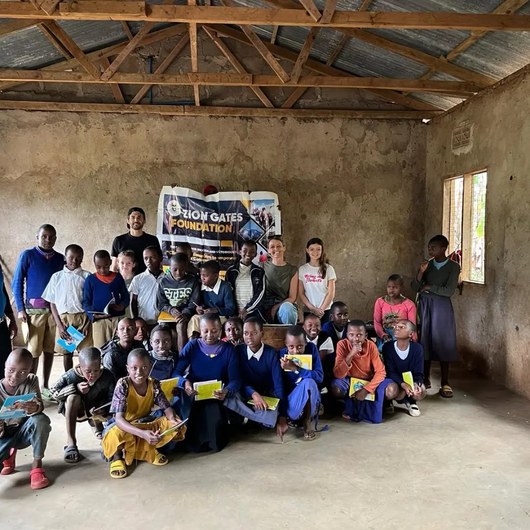 Children in a classroom with donated notebooks